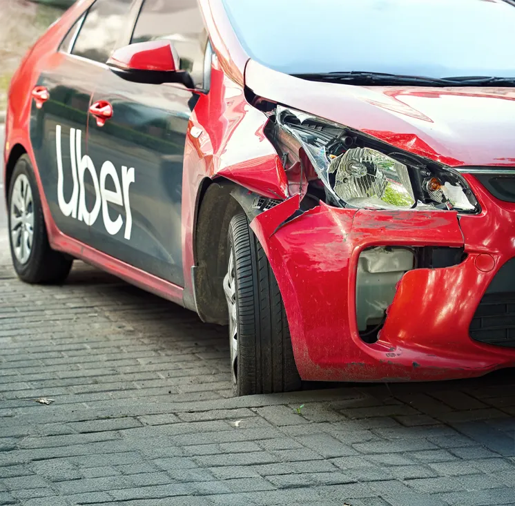 A rideshare vehicle at an intersection at night