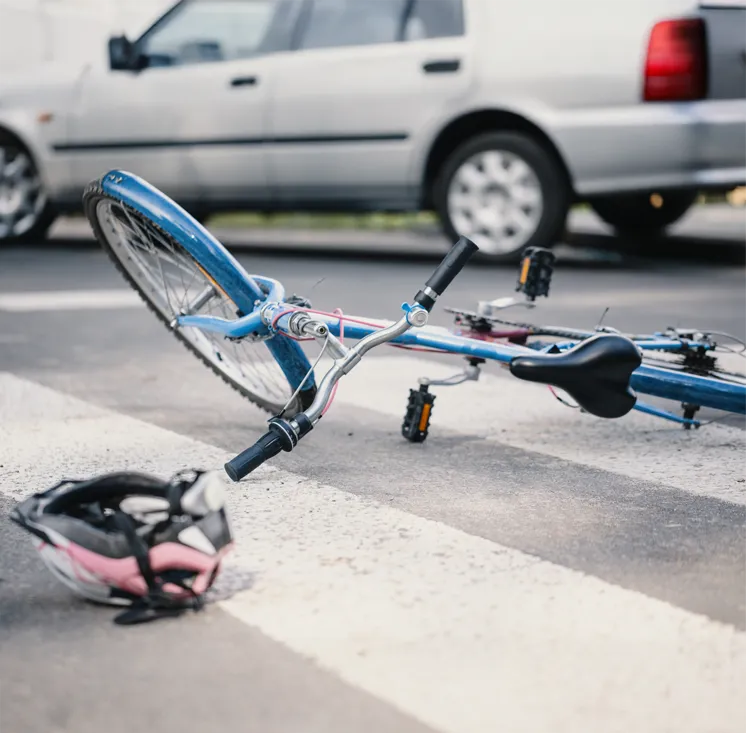 A damaged bicycle wheel on pavement